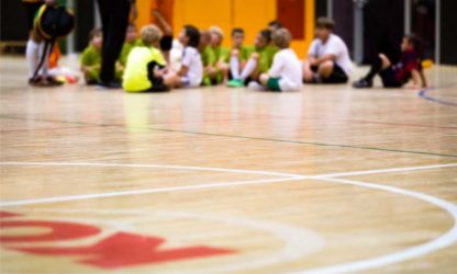 Physical Education Class. Indoor Soccer Training. Kids Futsal Team with Coach. Youth Sport Background Physical Education Class. Indoor Soccer Training. Kids Futsal Team with Coach. Youth Sport Background