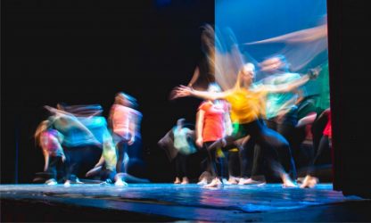 Group of dancer in colored clothes dancing on the stage in long Group of dancer in colored clothes dancing on the stage in long